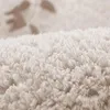 Close-up view of a textured beige carpet. Podgląd zdjęcia produktu