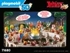 A group of Playmobil figures are gathered around a table laden with food, celebrating a birthday. Produktbild-Vorschau