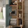 A bathroom cabinet with its door open, revealing shelves with towels and books. Náhled obrázku produktu