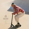 A young person riding a scooter in a skate park. Produktbild-Vorschau