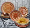 A collection of colorful, swirled ceramic plates and bowls, with two donuts on one of the plates and pasta in one of the bowls. Náhled obrázku produktu