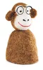 A felt monkey egg warmer with glasses and a smile, presented against a white background.