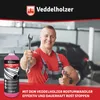 A mechanic holding a wrench and giving a thumbs up, with a bottle of rust converter in the foreground. Produktbild-Vorschau