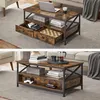 A rustic-style coffee table with storage drawers and shelves is shown in a living room setting. Produktbild-Vorschau