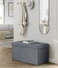 A storage ottoman in a hallway near a coat rack and mirror. Produktbild-Vorschau