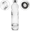 A clear glass bottle with a silver cap, shown against a white background. Insets show a close-up of the bottle's opening and the cap. Náhled obrázku produktu
