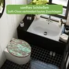 A bathroom scene featuring a toilet with a decorative seat and a sink. Produktbild-Vorschau
