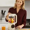 A woman is preparing a smoothie in a kitchen. Náhľad obrázku produktu