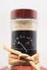 Close-up of the top of a rum bottle, showing the cap, label, and decorative twine. Produktbild-Vorschau