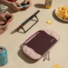 People playing video games on a table with snacks and drinks. Produktbild-Vorschau