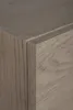 A close-up view of the corner of a wooden cabinet with a light brown and gray wood grain texture. Anteprima dell’immagine prodotto