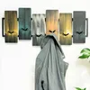 A coat rack with a jacket hanging on it, mounted on a white wall. Produktbild-Vorschau