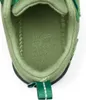 Close-up view of the inside of a green child's shoe. Produktbild-Vorschau