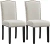 Two beige upholstered dining chairs with black legs and nailhead trim, presented against a white background. Podgląd zdjęcia produktu