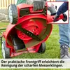 A person is cleaning the blade of a red lawnmower. Produktbild-Vorschau