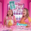Two young girls are excitedly holding potion-making supplies in a brightly lit, pink-themed room. Produktbild-Vorschau