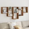 A wooden wall shelf unit is mounted on a white wall above a sofa. Náhled obrázku produktu