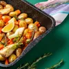 A close-up view of a baking tray filled with roasted vegetables and herbs. Produktbild-Vorschau