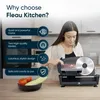 A woman using a food slicer in a kitchen. Anteprima dell’immagine prodotto