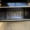 Close-up view of a metal grate with a flame symbol, likely part of a grill or smoker. Náhľad obrázku produktu
