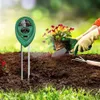 A person is planting flowers in the soil with a soil testing meter nearby. Podgląd zdjęcia produktu