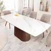 A dining room scene with a large marble-patterned table and chairs. Produktbild-Vorschau
