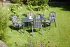 A garden table and chairs set on a green lawn with plants in the background. Produktbild-Vorschau