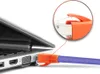 A close-up view of an orange RJ45 network connector being plugged into a laptop's Ethernet port. A magnified inset shows the detail of the connector. Produktbild-Vorschau