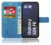 A blue flip case for a Samsung Galaxy S24 FE phone, shown open with cards and euro banknotes inserted. Produktbild-Vorschau