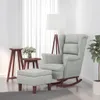 A light gray velvet rocking chair with an ottoman in a well-lit room with sheer curtains and a floor lamp. Náhľad obrázku produktu