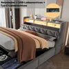 A modern upholstered bed with integrated storage and lighting. Náhled obrázku produktu