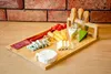 A charcuterie board with various cheeses, meats, and cherry tomatoes, along with a set of cheese knives. Náhľad obrázku produktu