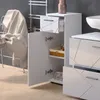 A close-up view of a white high-gloss bathroom cabinet with an open door and drawer, showing storage space and towels. Voir les images du produit