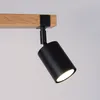 A close-up shot of a black spotlight attached to a wooden beam. Podgląd zdjęcia produktu