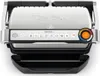 A top-down view of an open electric grill. Voir les images du produit