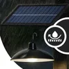 A solar-powered hanging lamp is shown in the rain, with a circular icon indicating water resistance. Anteprima dell’immagine prodotto