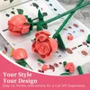 Building blocks for roses are laid out on an instruction manual. Produktbild-Vorschau
