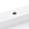 A close-up view of a white sink with a single hole drilled into its surface. Produktbild-Vorschau