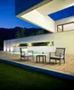 A modern outdoor patio at dusk with two chairs and a small table. Anteprima dell’immagine prodotto