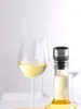 A wine bottle with a vacuum stopper and two wine glasses in the background. Produktbild-Vorschau