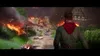 A man walks through a burning village, with bodies scattered on the ground. Produktbild-Vorschau