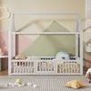 A child's bed with a house frame, set in a room with a geometric wall pattern and toys on the floor. Anteprima dell’immagine prodotto