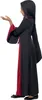 A young girl wearing a black and red hooded costume, with her left hand outstretched. Produktbild-Vorschau