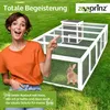 A woman is pointing to a rabbit run in a grassy outdoor setting. Produktbild-Vorschau