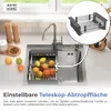 A kitchen sink with a drying rack filled with fruit, next to a faucet and soap dispenser. Produktbild-Vorschau