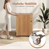 A woman is pushing a wooden cabinet with wheels, showcasing its mobility. A close-up of a wheel with a brake is also shown. Produktbild-Vorschau