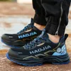 A close-up shot of a person wearing black work shoes with blue and gold accents. Produktbild-Vorschau