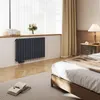 A bedroom with a radiator, bed, and nightstand. Anteprima dell’immagine prodotto
