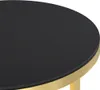 A close-up view of the edge of a round table with a black surface and a gold rim. Náhľad obrázku produktu