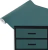 A roll of teal matte vinyl wrap is shown unfurling over a black dresser with two teal drawers. Produktbild-Vorschau